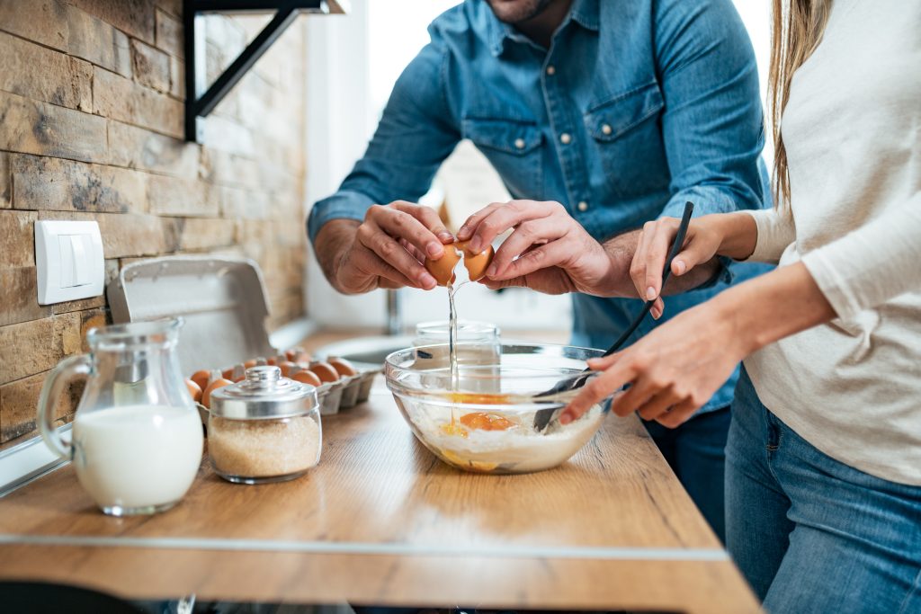 Close Up Of A Young Couple Cooking Together.