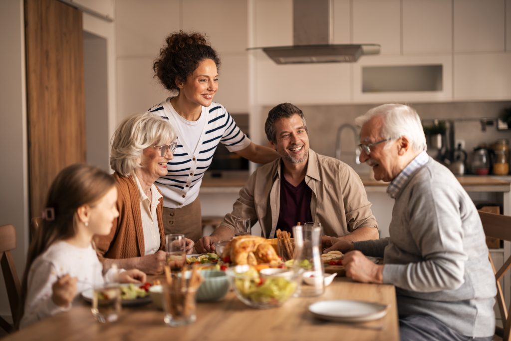 Multi Generational Family Having Fun Enjoying Thanksgiving Lunch Together